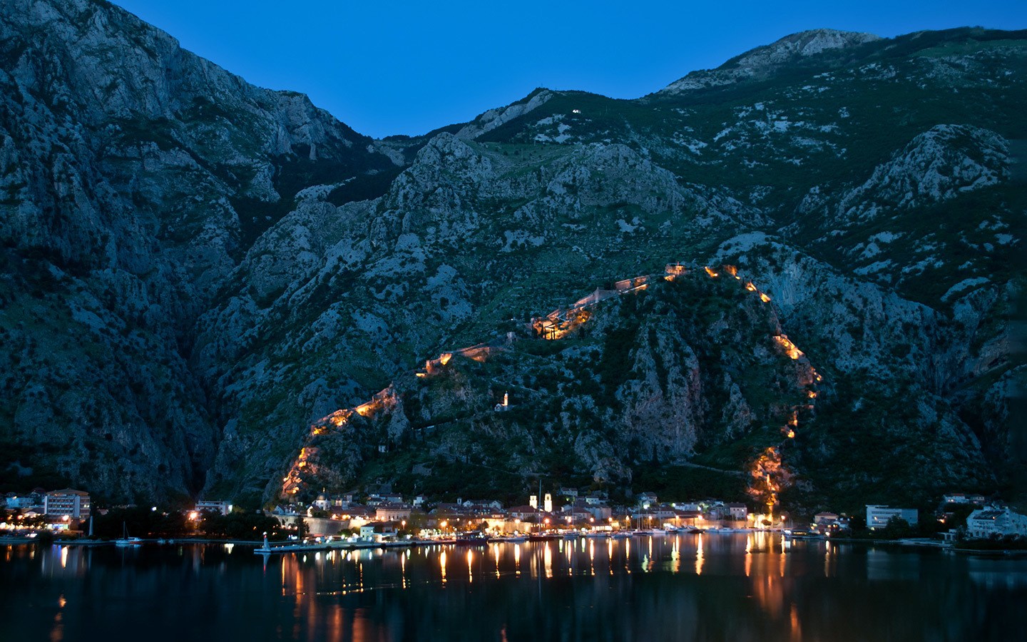 Kotor city walls lit up at night