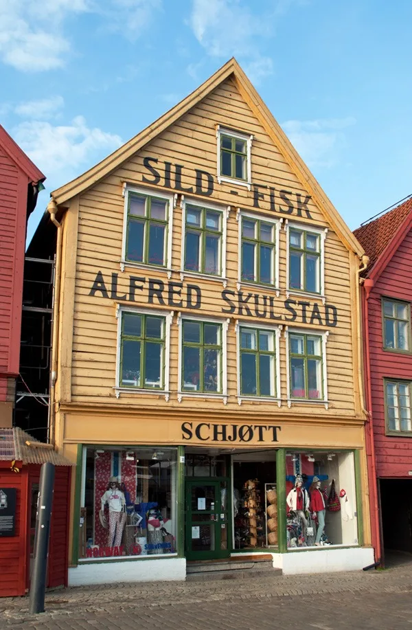 Among the colourfully painted shopfronts of Bryggen, the historic waterfront district of the Norwegian city of Bergen – ontheluce.com