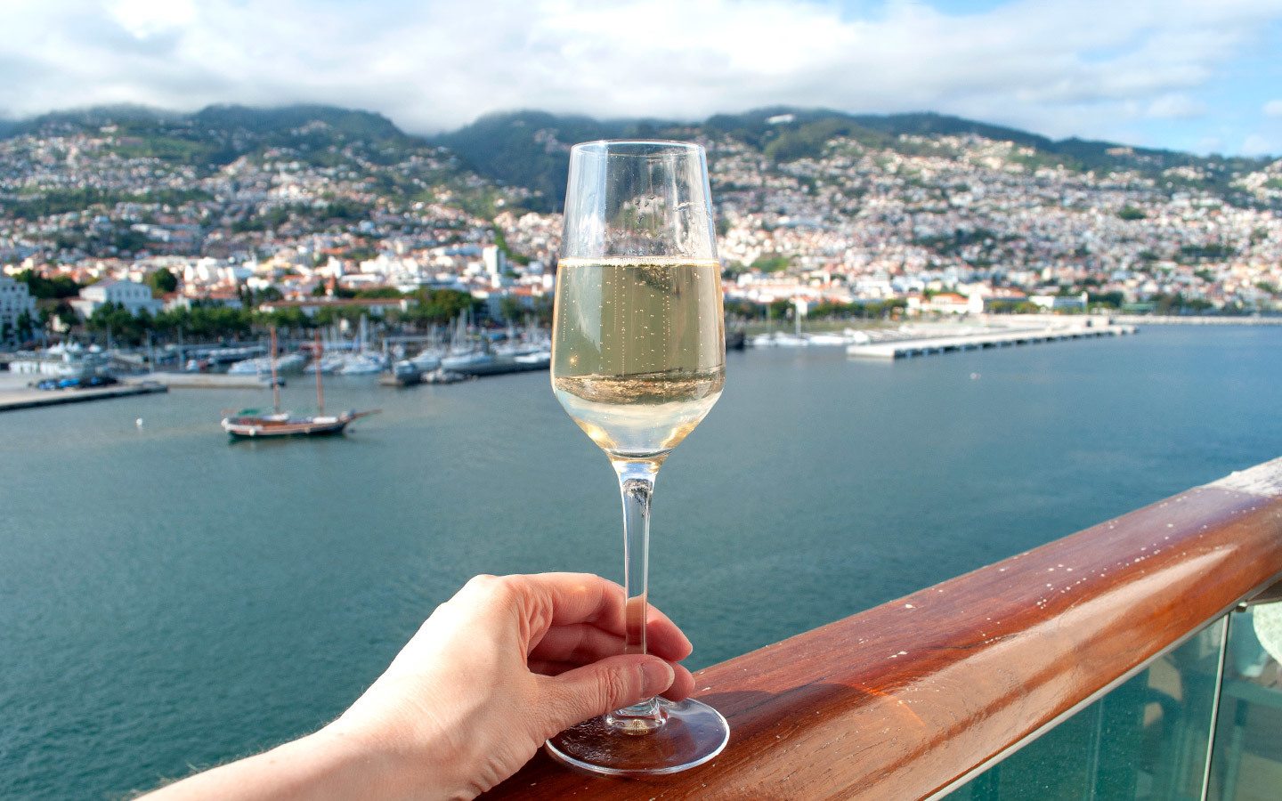 Glass of Champagne on cruise ship balcony overlooking Madeira