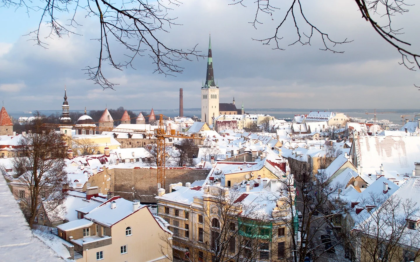 Snowy rooftops and church spires from the Kohtuotsa viewpoint in Tallinn in winter