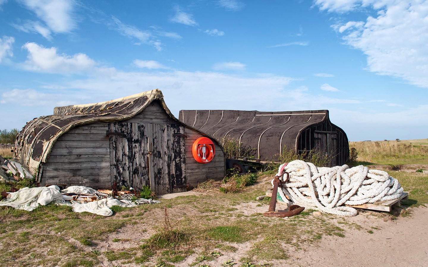 Boats turned sheds in the harbour on Lindisfarne island