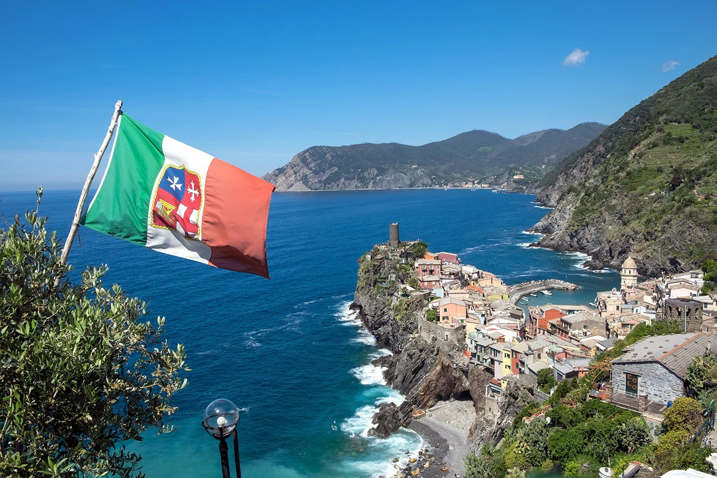 Vernazza from the cliff path with a flag blowing in the wind