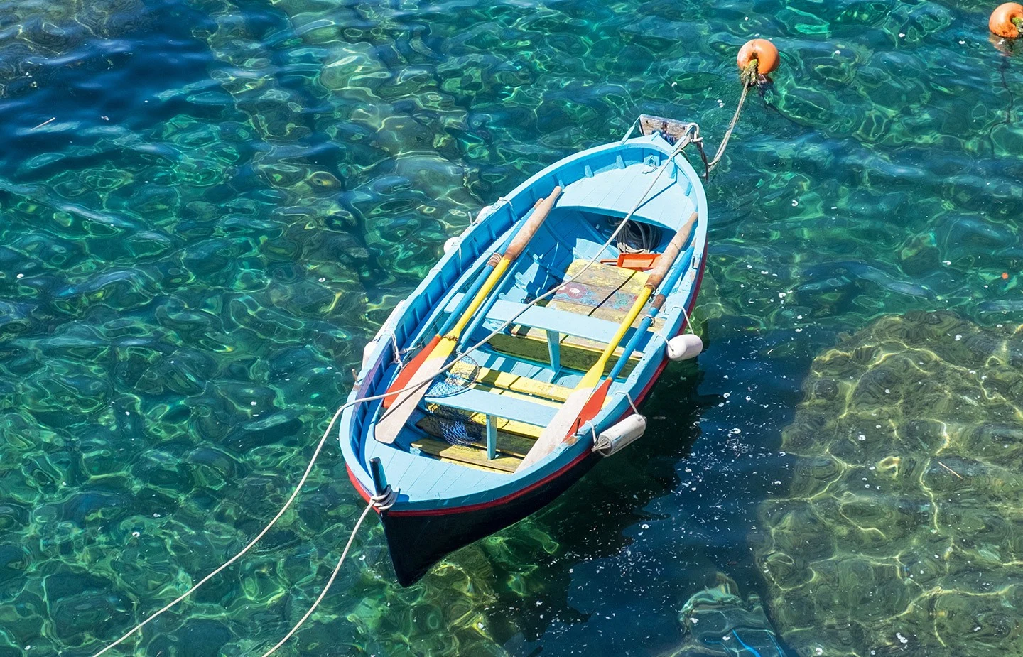 Rowing boat in the clear blue seas of Italy