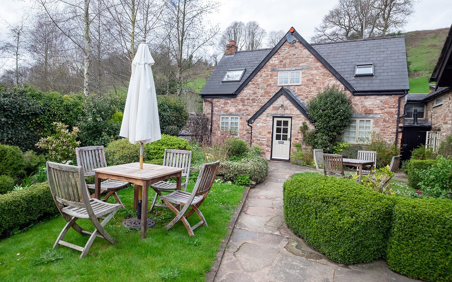 Exploring England's Forest of Dean with a luxury stay at the Tudor Farmhouse hotel in Clearwell, a former farm turned boutique hotel with award-winning restaurant, surrounded by Forest of Dean attractions like Puzzlewood and Clearwell Caves. 