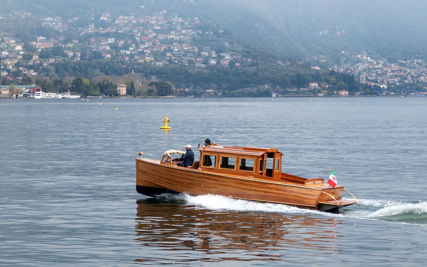 A classic wooden Riva speedboat on the lake