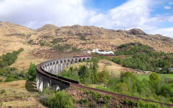 The Jacobite steam train crosses the Glenfinnan Viaduct