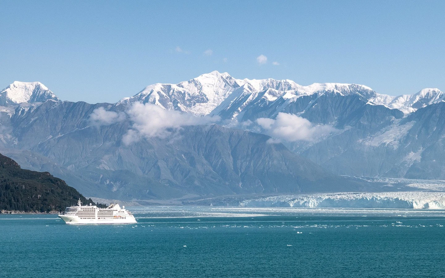 Cruise ship sailing through Alaskan mountain peaks