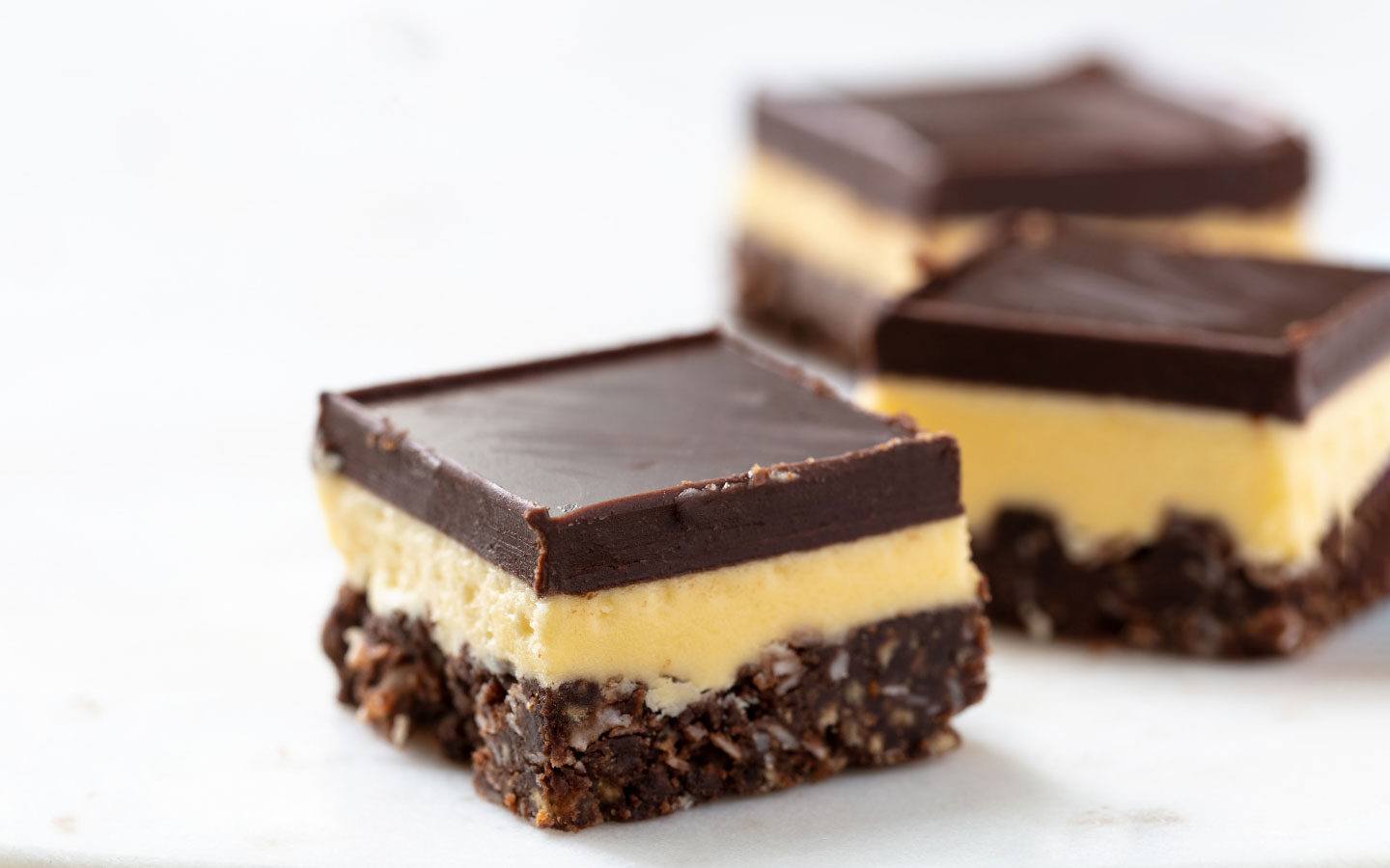 Nanaimo Bar – a biscuit crumb base, buttercream layer and dark chocolate topping