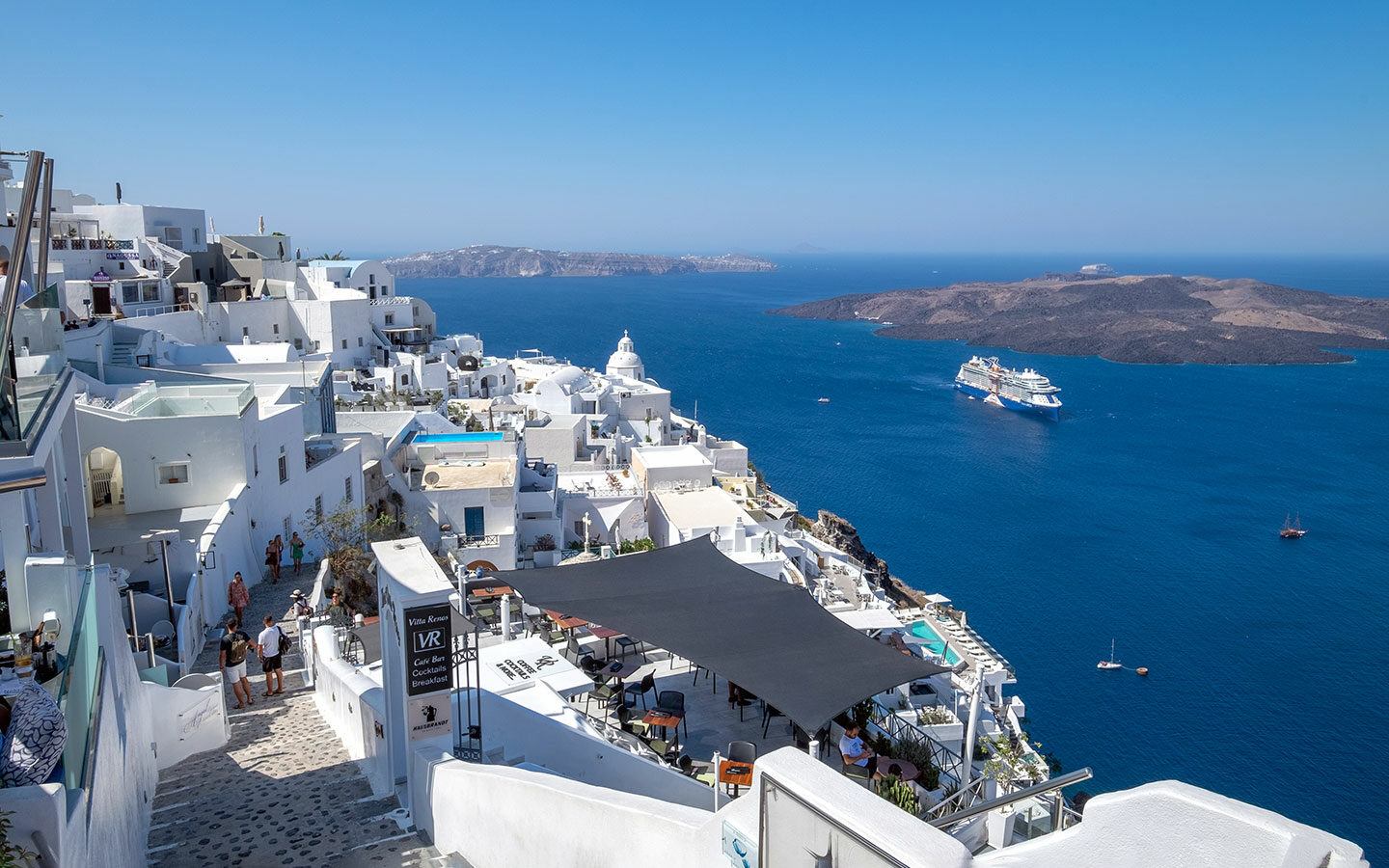 Looking down on Fira, Santorini, with Celebrity Apex cruise ship in the distance