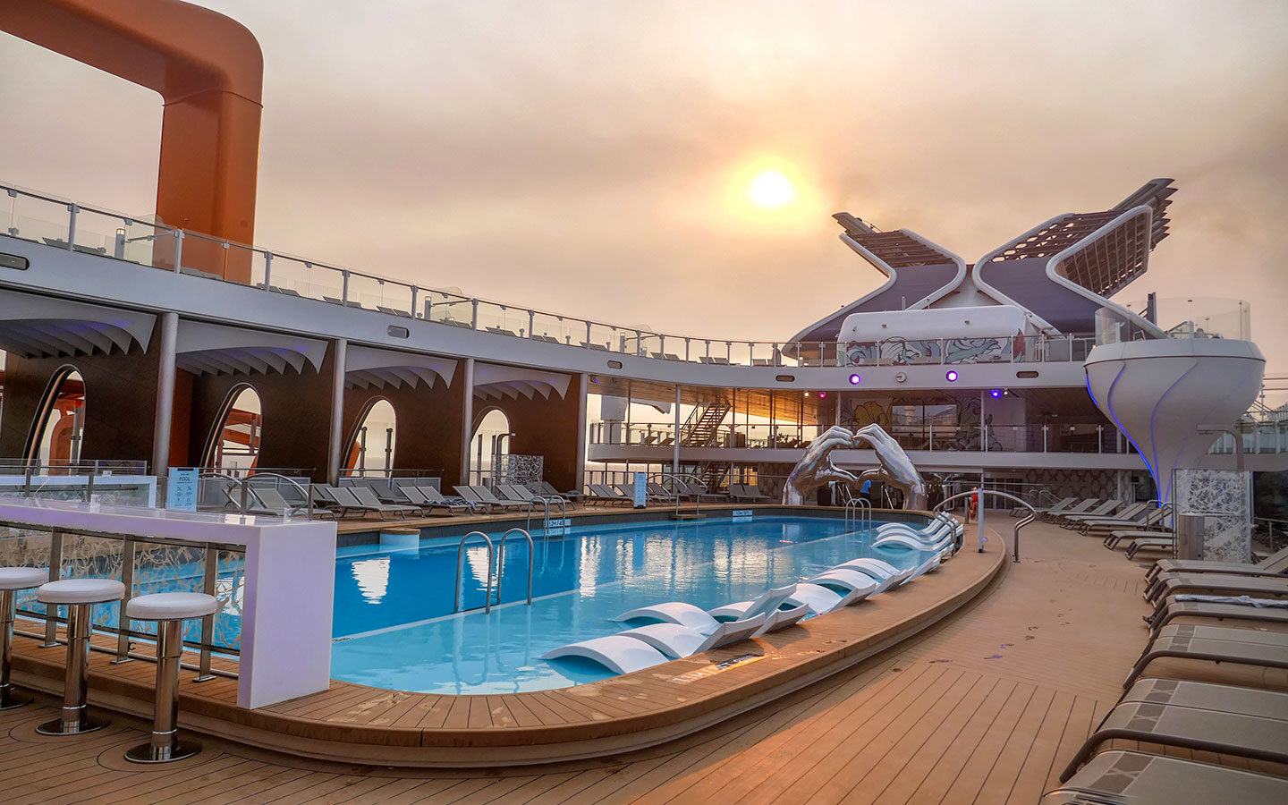 Pool on board Celebrity Apex at sunset