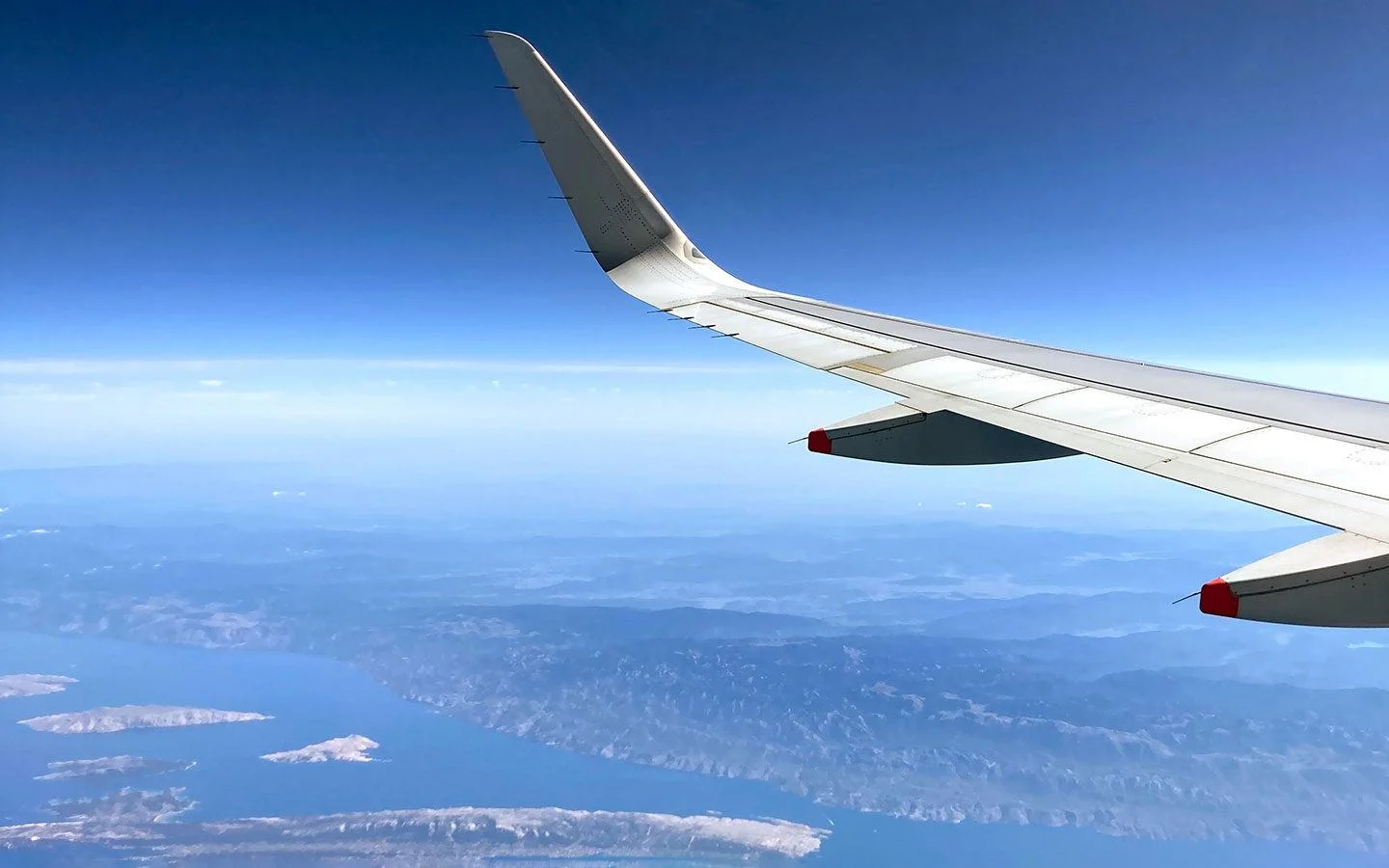 Plane wing from the window of a plane flying over Greece