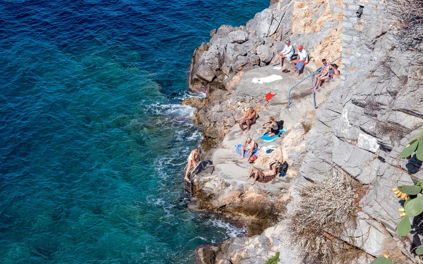 Swimmers at Hydronetta swimming platform in Hydra, Greece