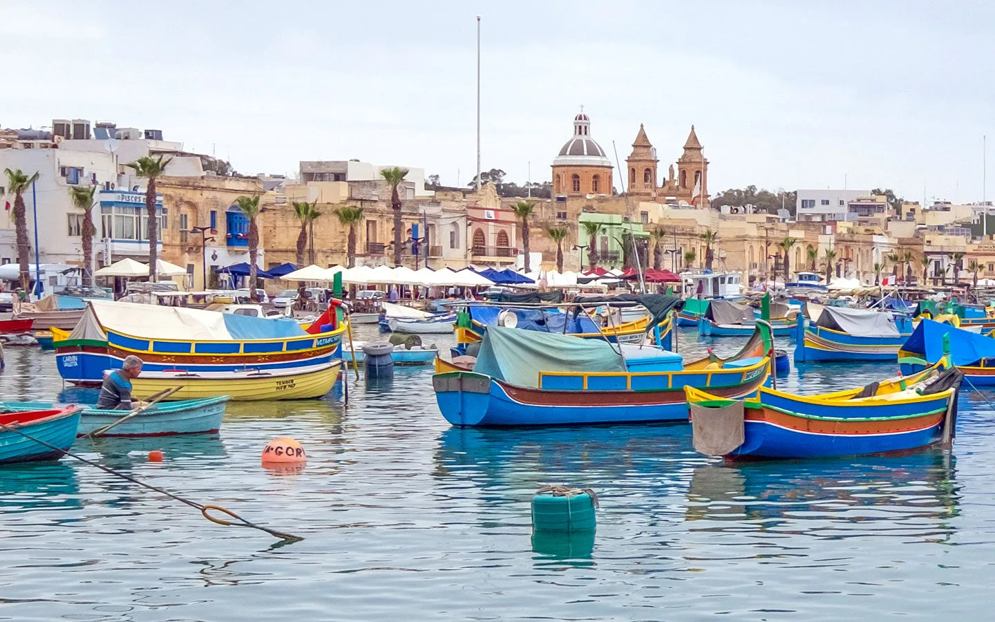 Colourful traditional luzzu boats in the harbour at Marsaxlokk, Malta