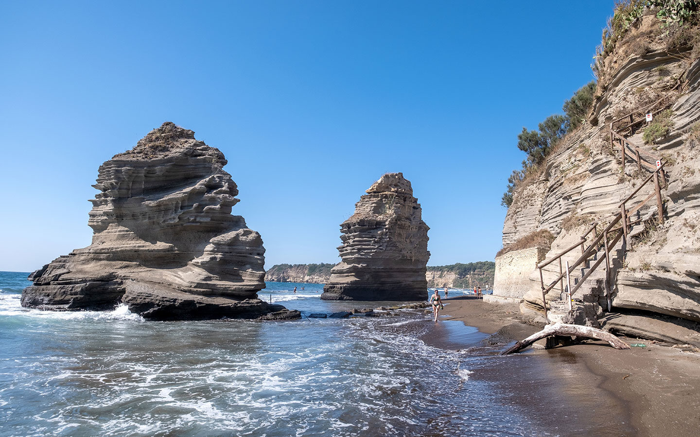 The Faraglioni di Procida rock stacks on Chiaiolella beach in Procida