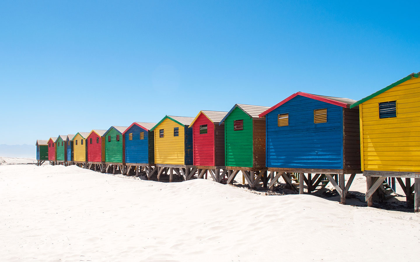 Brightly painted beach huts in Muizenberg, South Africa