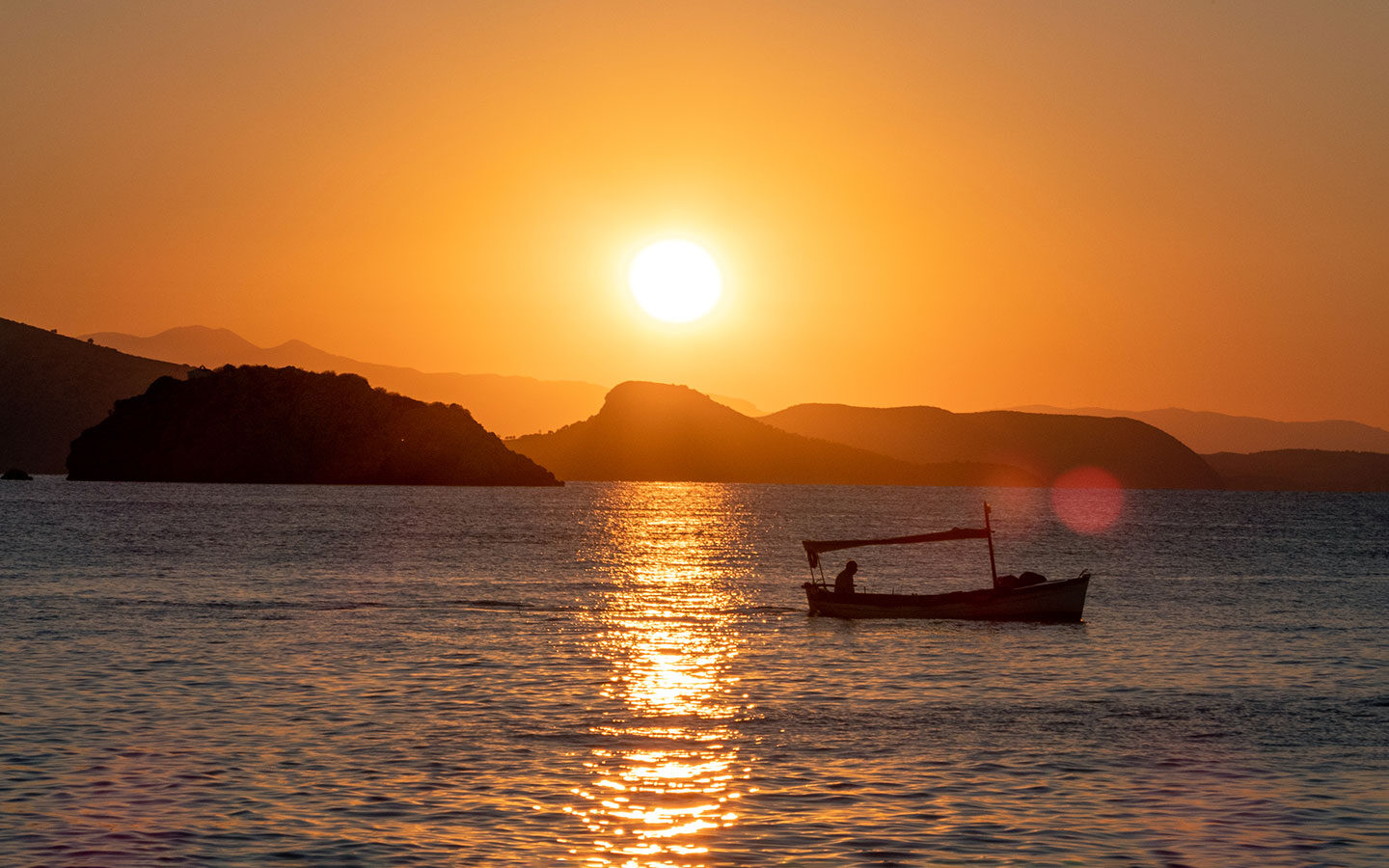 Boat at sunset on Hydra island Greece