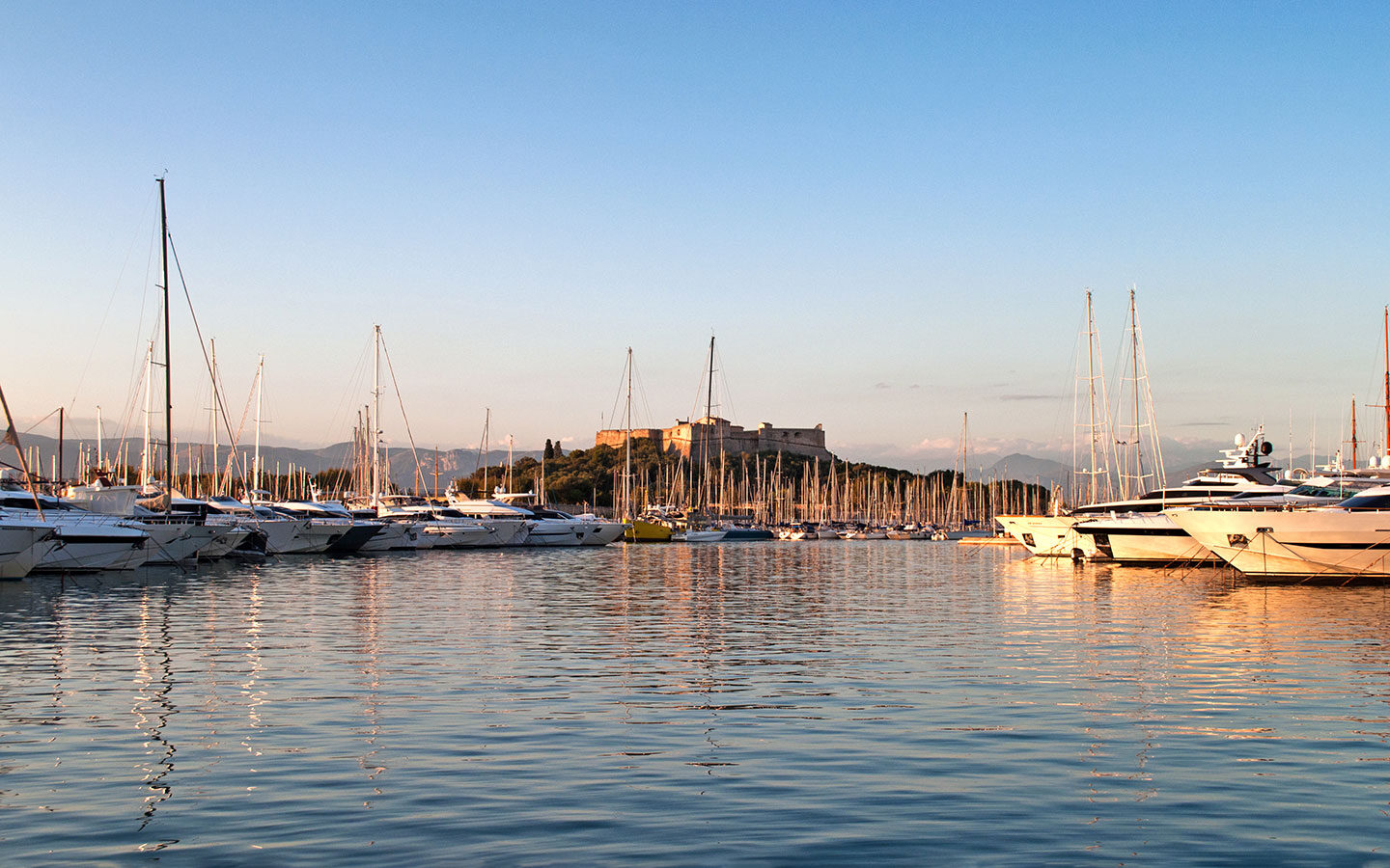 Boats in the harbour in Antibes at sunset