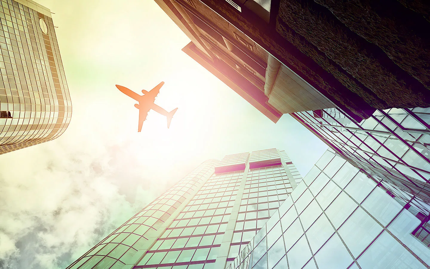 Plane flying above skyscrapers