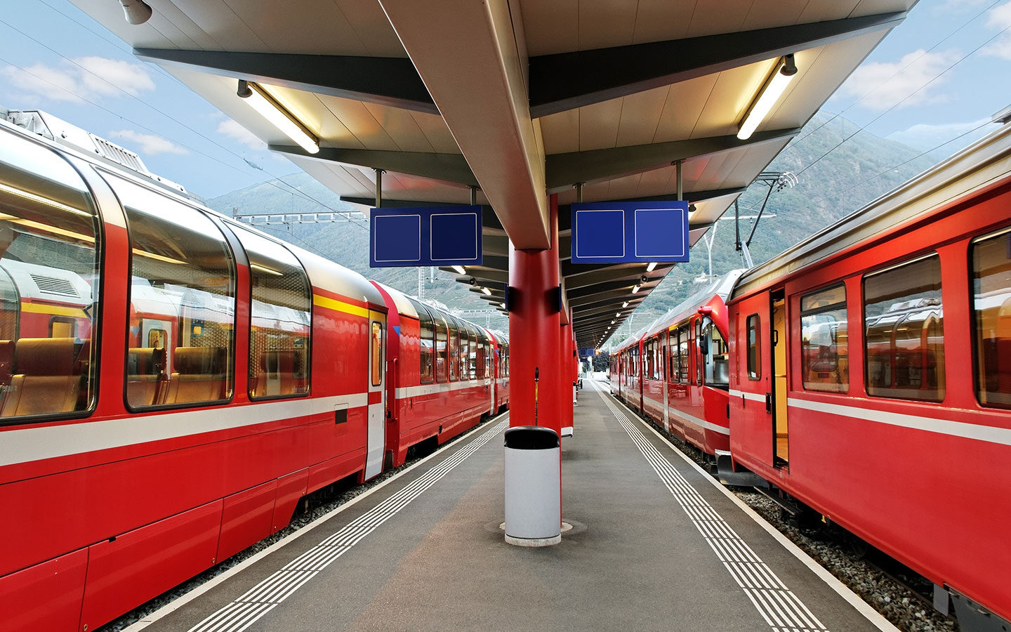 Local and panoramic Swiss trains together on the platform